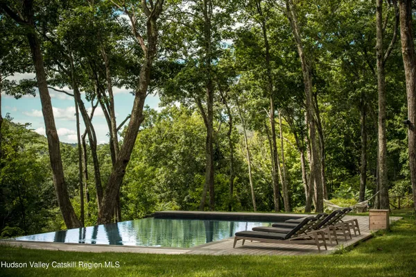 a view of a backyard with large trees
