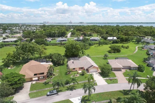 an aerial view of multiple houses with yard
