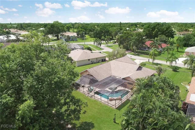 an aerial view of residential houses with outdoor space and river