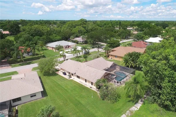 an aerial view of a house with garden space and street view