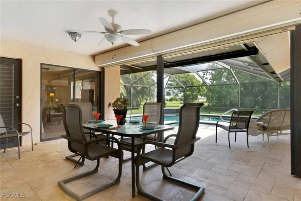 a dining room with furniture and a floor to ceiling window