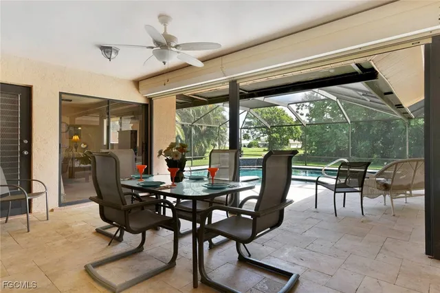 a dining room with furniture and a floor to ceiling window