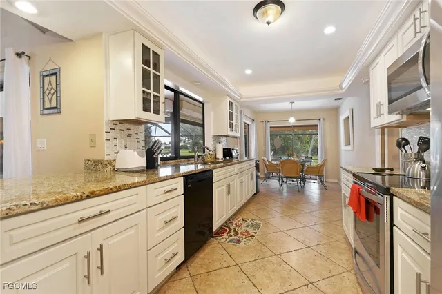 a kitchen with stainless steel appliances granite countertop a sink and cabinets