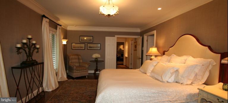 11114 Cripplegate Road Potomac, MD 20854 - Photo 17 of 30 a bedroom with a bed and a chandelier
