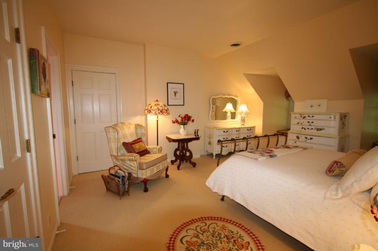 11114 Cripplegate Road Potomac, MD 20854 - Photo 18 of 30 a bed room with a bed and a chair