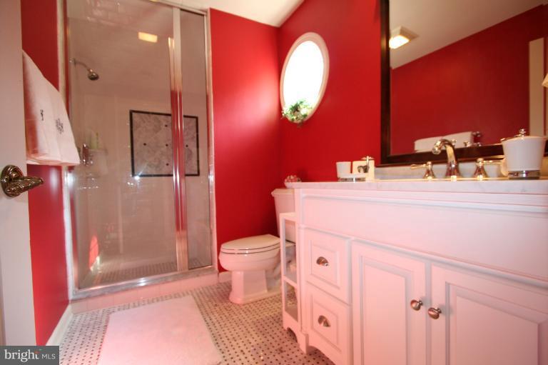 11114 Cripplegate Road Potomac, MD 20854 - Photo 20 of 30 a bathroom with a sink toilet vanity and shower