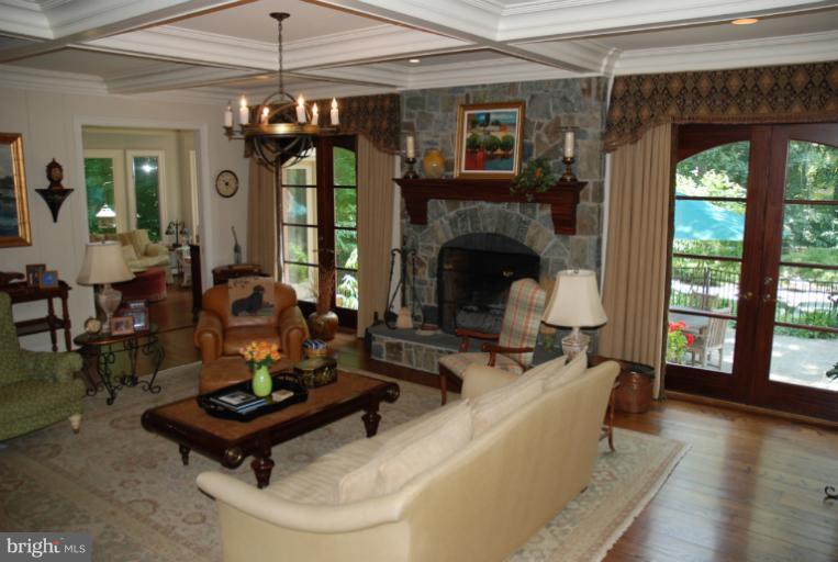 11114 Cripplegate Road Potomac, MD 20854 - Photo 9 of 30 a living room with furniture a table and a fireplace