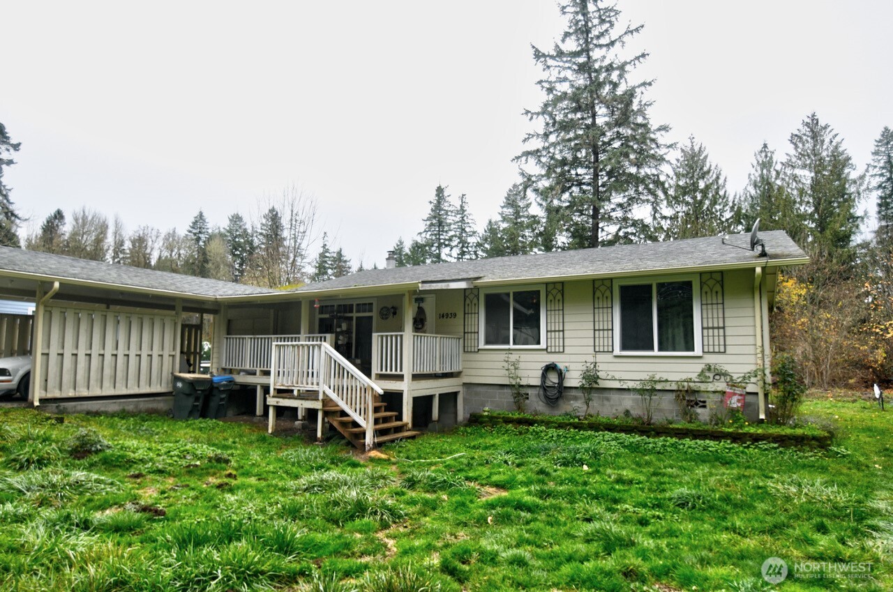 a view of a house with backyard sitting area and garden