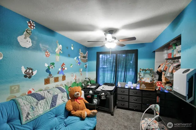 a bed room with furniture and a flat screen tv