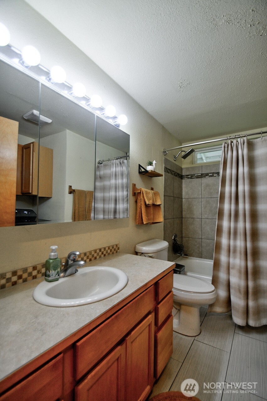 14939 Turner Road Southeast Rainier, WA 98576 - Photo 13 of 24 a bathroom with a sink a toilet and shower