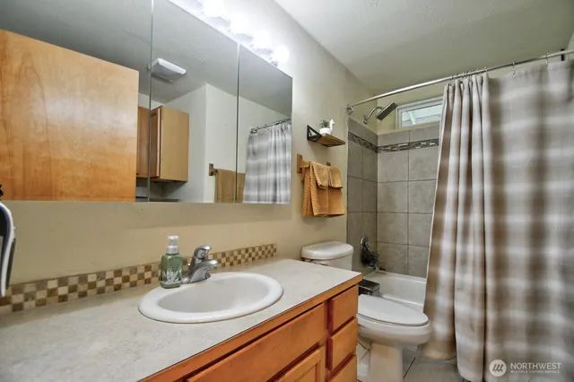 a bathroom with a sink toilet and shower