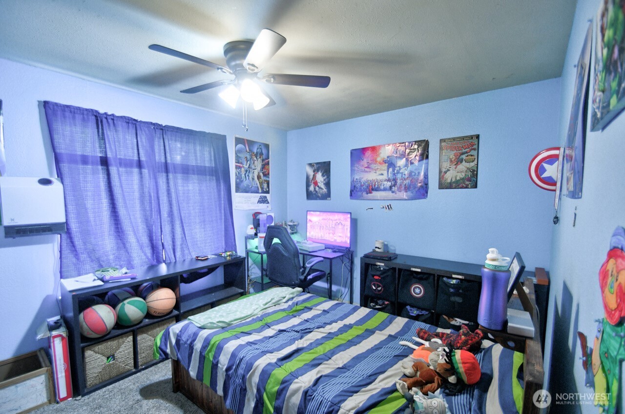 14939 Turner Road Southeast Rainier, WA 98576 - Photo 16 of 24 a bedroom with bed and a chair