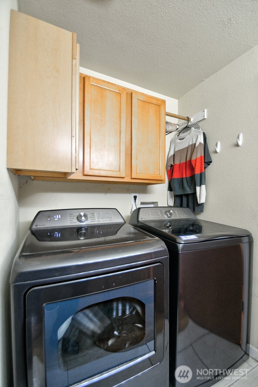 14939 Turner Road Southeast Rainier, WA 98576 - Photo 20 of 24 a utility room with stainless steel appliances granite countertop a stove a washer and dryer