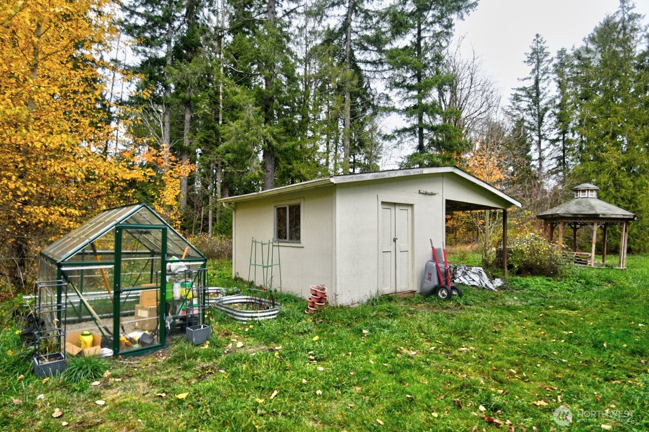 14939 Turner Road Southeast Rainier, WA 98576 - Photo 22 of 24 a view of backyard of house with wooden fence and large trees