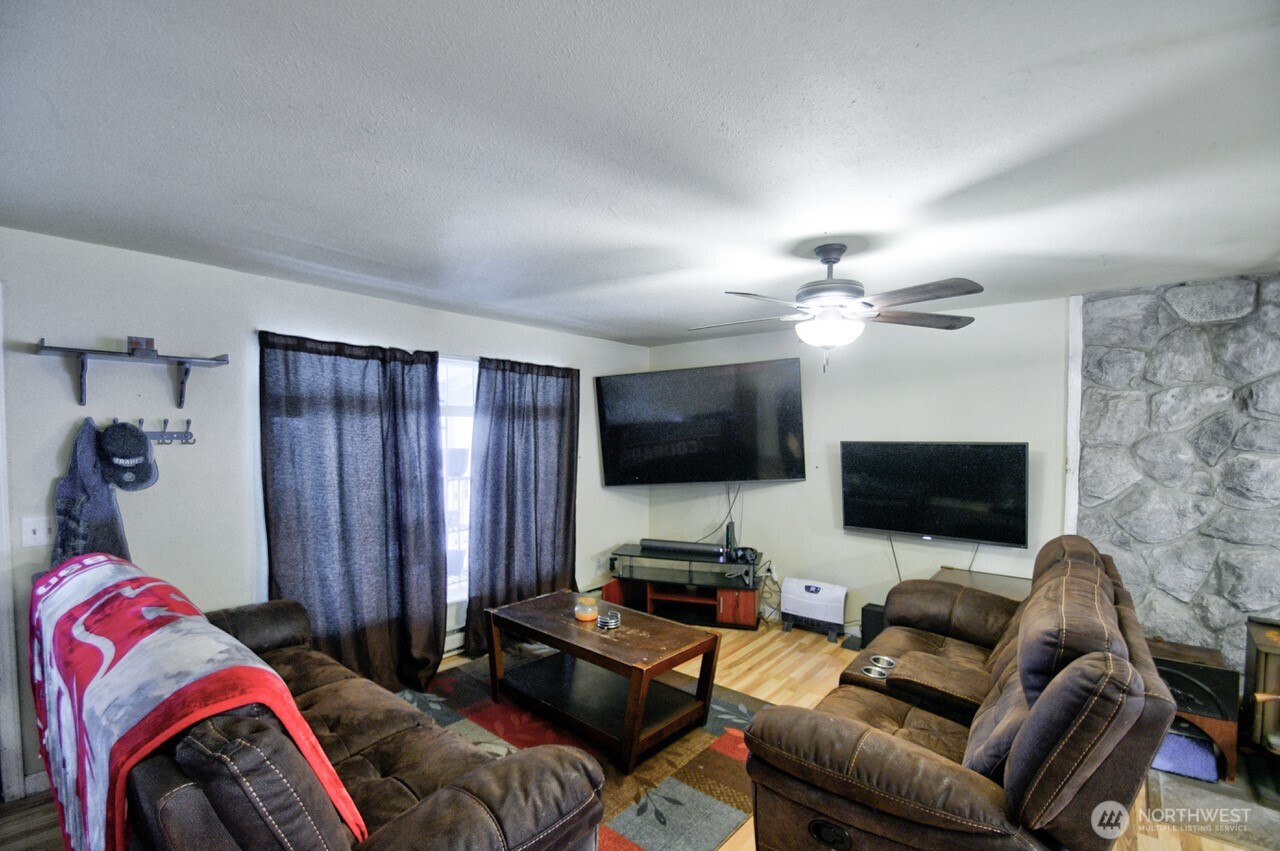 14939 Turner Road Southeast Rainier, WA 98576 - Photo 3 of 24 a living room with furniture and a flat screen tv