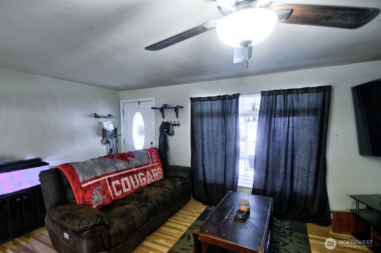 14939 Turner Road Southeast Rainier, WA 98576 - Photo 4 of 24 a living room with furniture and a flat screen tv