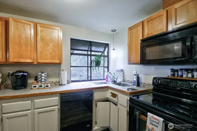 a kitchen with stainless steel appliances a sink stove and microwave