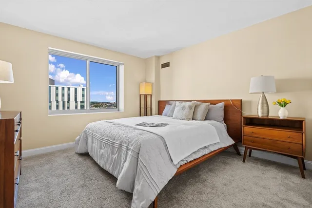 a spacious bedroom with a bed and a couch