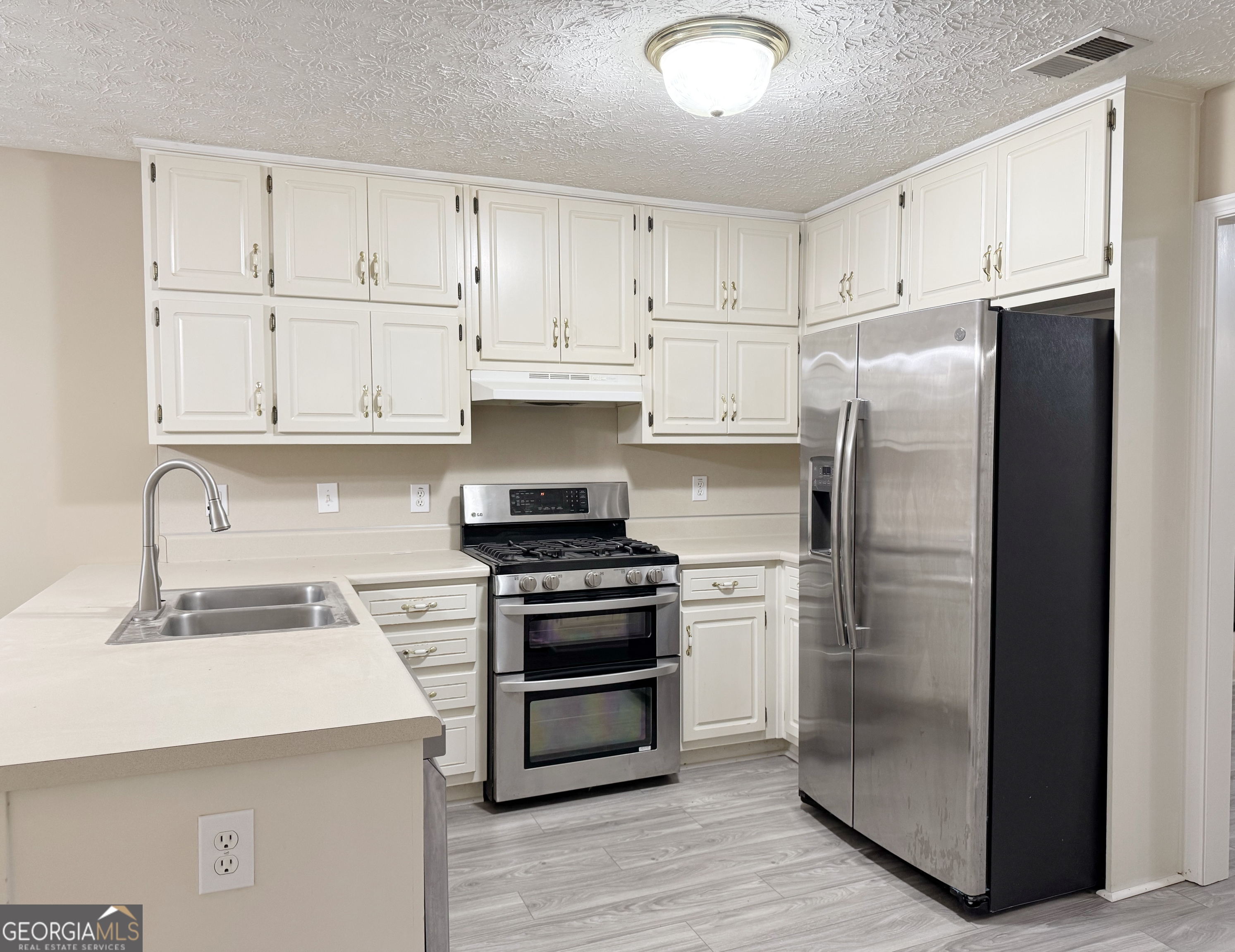 1150 Strath Clyde Way McDonough, GA 30253 - Photo 11 of 28 a kitchen with cabinets and stainless steel appliances