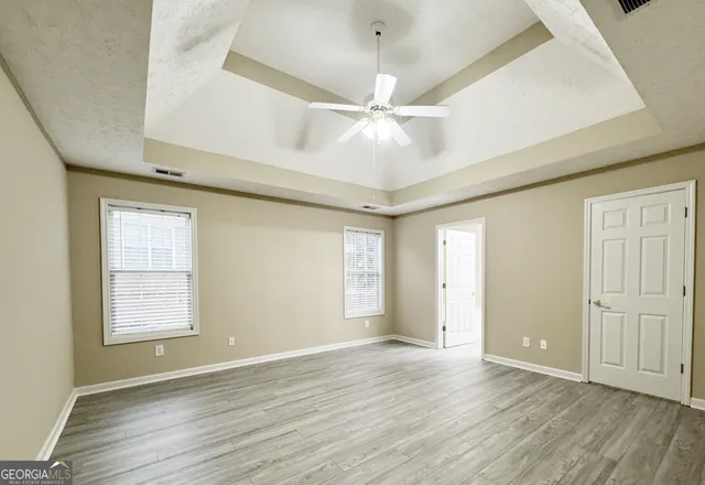 a view of an empty room with wooden floor