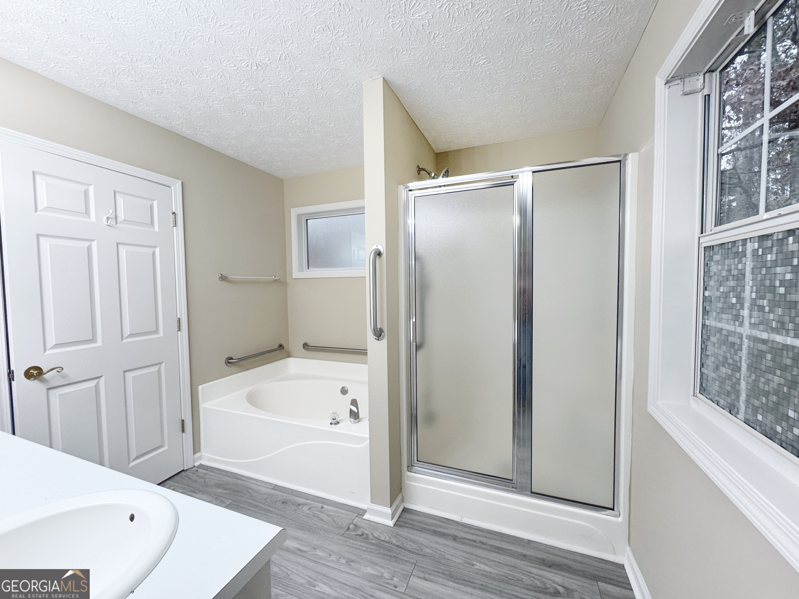 1150 Strath Clyde Way McDonough, GA 30253 - Photo 20 of 28 a bathroom with a tub shower and sink