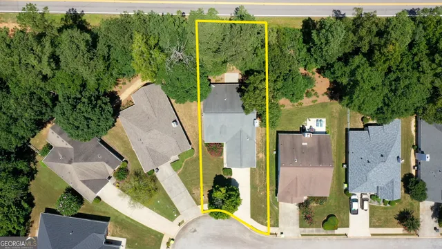 an aerial view of a house with a yard and potted plants