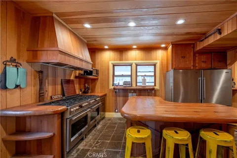 a large kitchen with a table and chairs