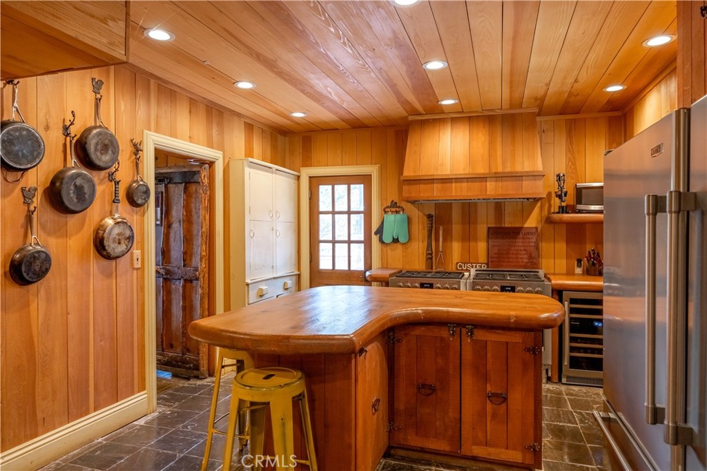 869 Knickerbocker Road Big Bear Lake, CA 92315 - Photo 20 of 50 a kitchen with stainless steel appliances granite countertop a stove a sink and a refrigerator