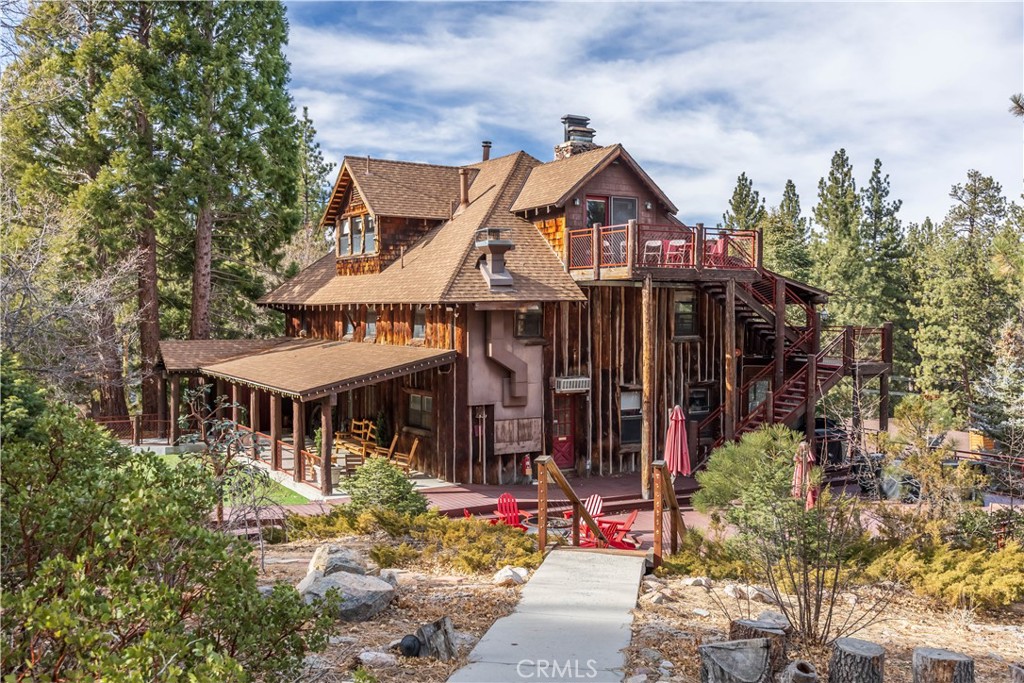 869 Knickerbocker Road Big Bear Lake, CA 92315 - Photo 2 of 50 a front view of a house with a porch and a tree