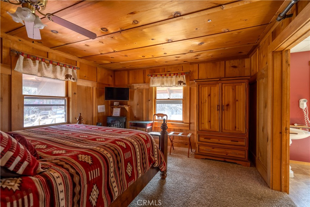 869 Knickerbocker Road Big Bear Lake, CA 92315 - Photo 23 of 50 a bedroom with a bed and wooden floor