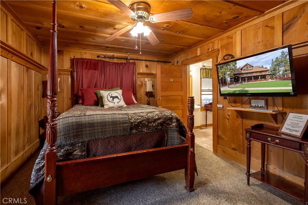 869 Knickerbocker Road Big Bear Lake, CA 92315 - Photo 27 of 50 a bedroom with a bed and a flat screen tv