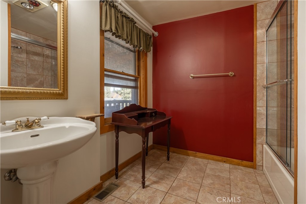 869 Knickerbocker Road Big Bear Lake, CA 92315 - Photo 28 of 50 a bathroom with a sink a toilet and shower