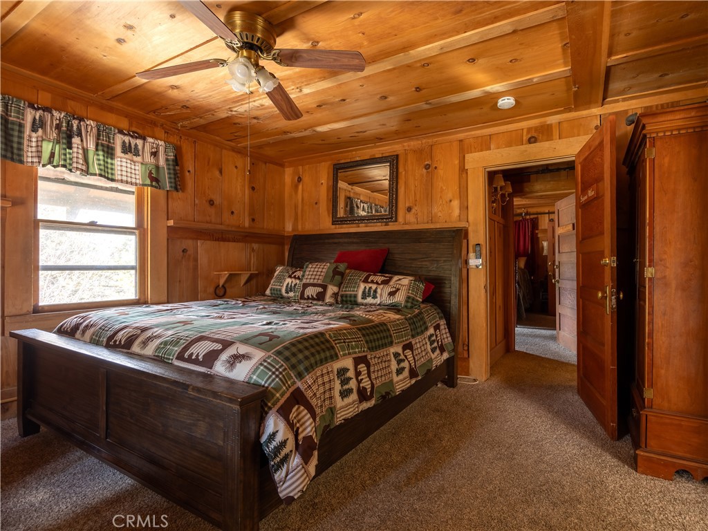 869 Knickerbocker Road Big Bear Lake, CA 92315 - Photo 29 of 50 a bed sitting in a bedroom next to a window