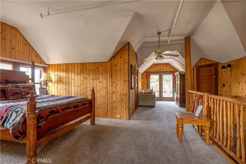 a roof deck with table and chairs and potted plants