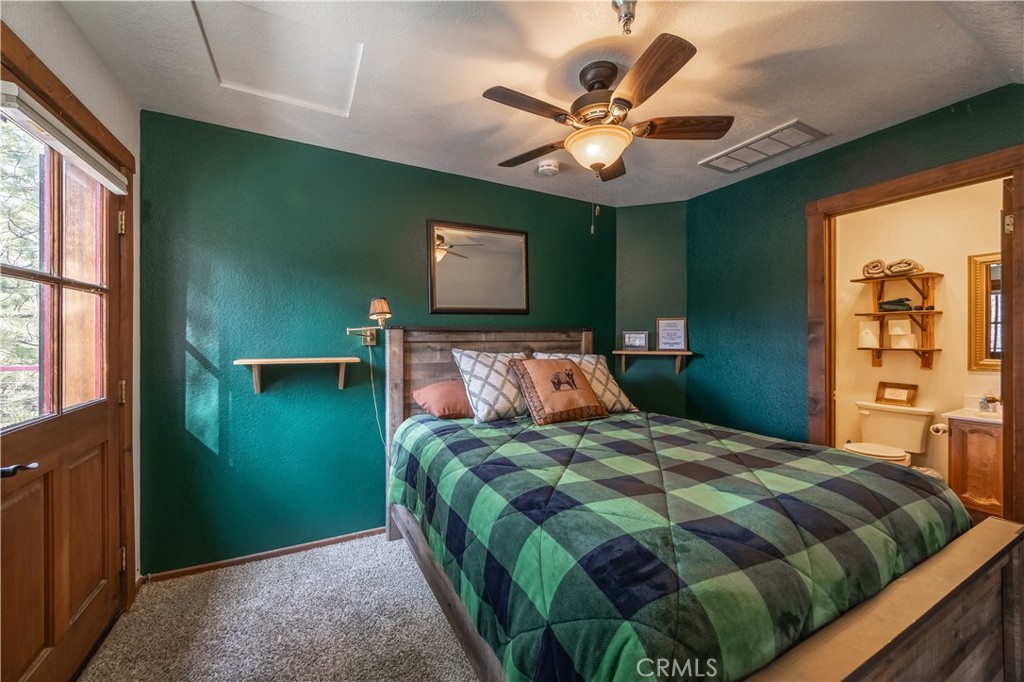 869 Knickerbocker Road Big Bear Lake, CA 92315 - Photo 40 of 50 a bedroom with a large bed chandelier and a window