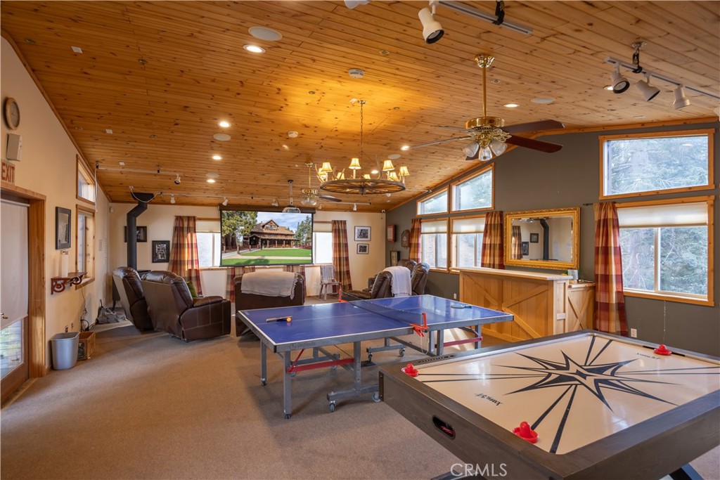 869 Knickerbocker Road Big Bear Lake, CA 92315 - Photo 49 of 50 a living room with furniture a flat screen tv and a chandelier