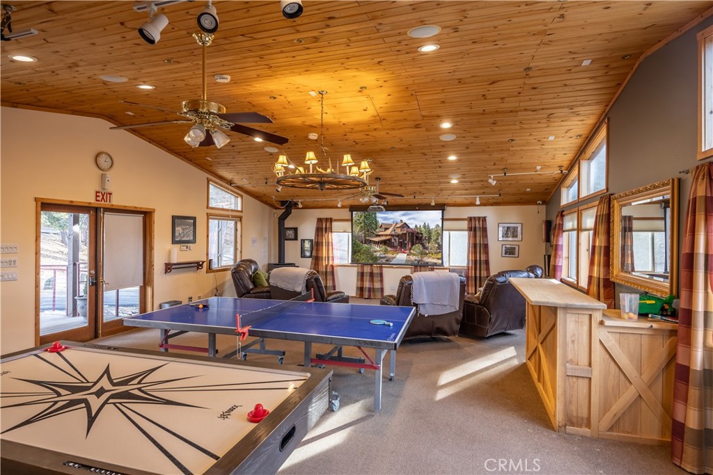 869 Knickerbocker Road Big Bear Lake, CA 92315 - Photo 50 of 50 a living room with furniture a chandelier and a dining table
