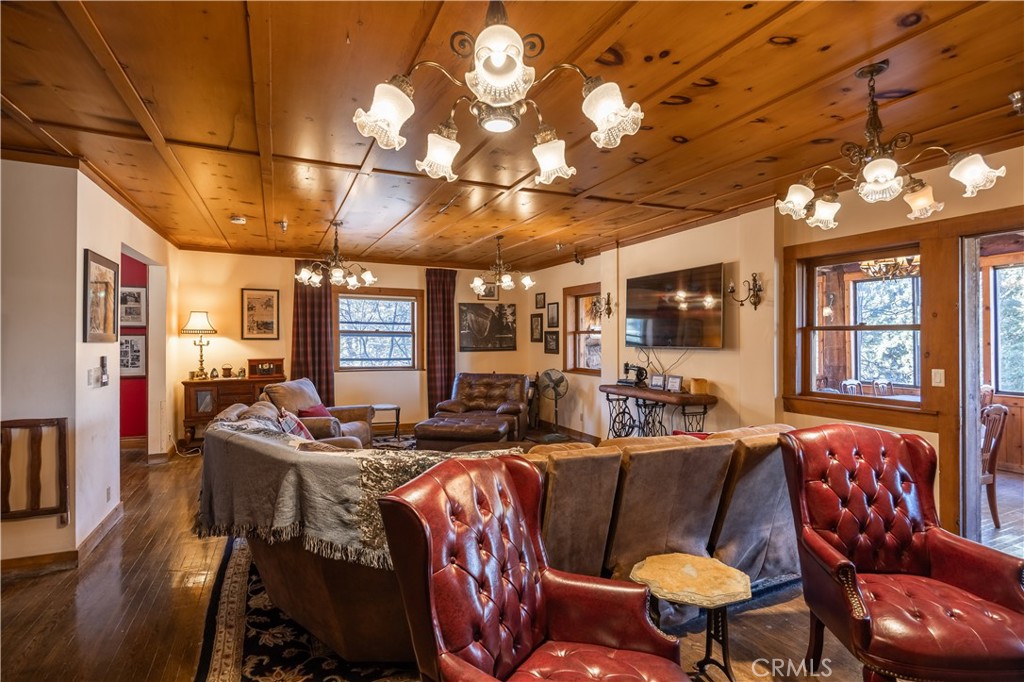 869 Knickerbocker Road Big Bear Lake, CA 92315 - Photo 7 of 50 a living room with furniture a chandelier and a dining table