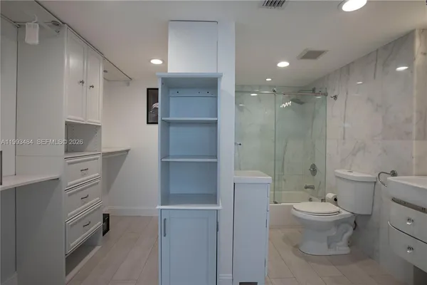 a bathroom with a toilet sink and shower