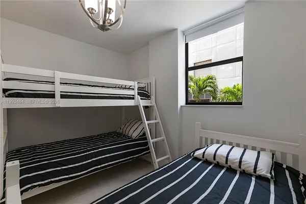 a bedroom with bunk bed and a window