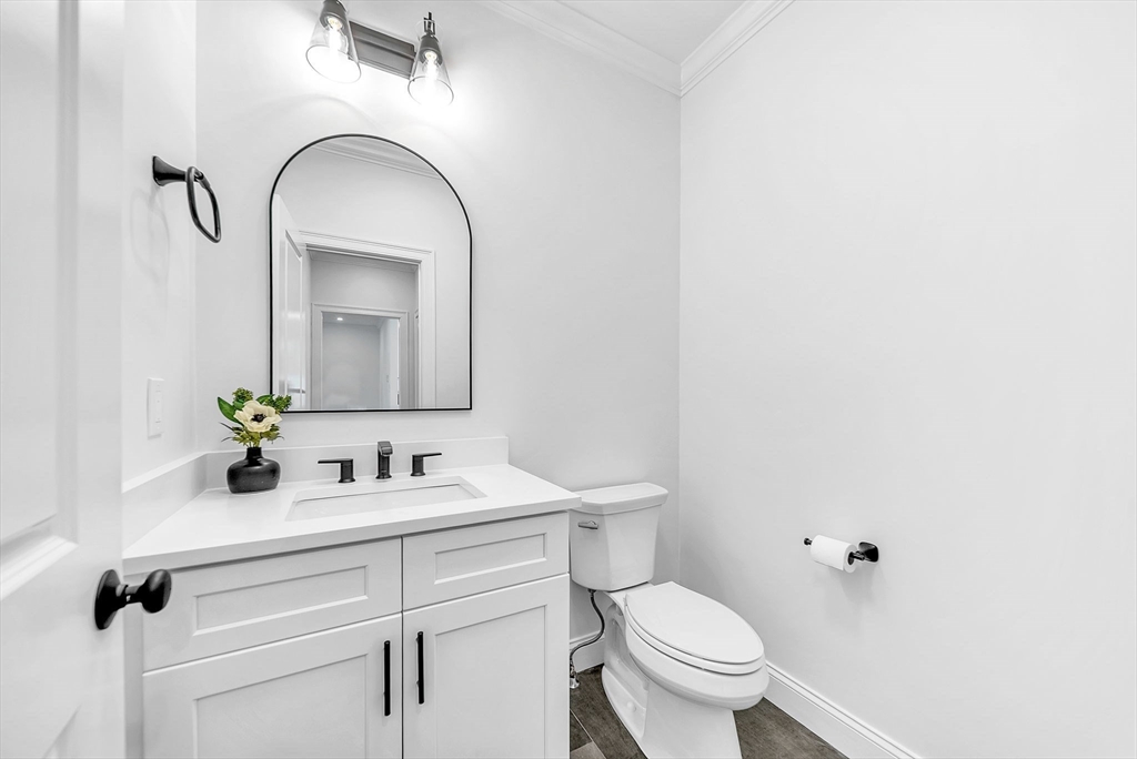 57 Raymond Street, Unit 2 Franklin, MA 02038 - Photo 16 of 41 a bathroom with a toilet sink and mirror