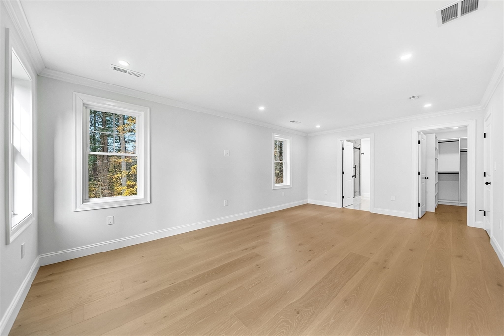 57 Raymond Street, Unit 2 Franklin, MA 02038 - Photo 19 of 41 a view of an empty room with a window and a kitchen