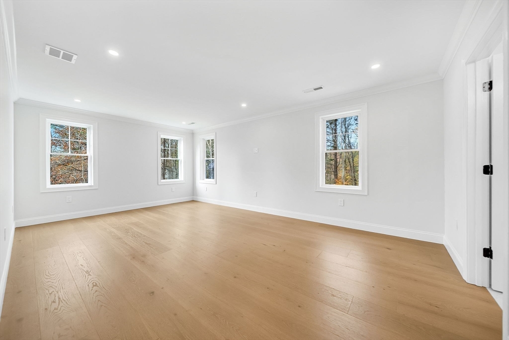 57 Raymond Street, Unit 2 Franklin, MA 02038 - Photo 21 of 41 a view of an empty room with a window and wooden floor
