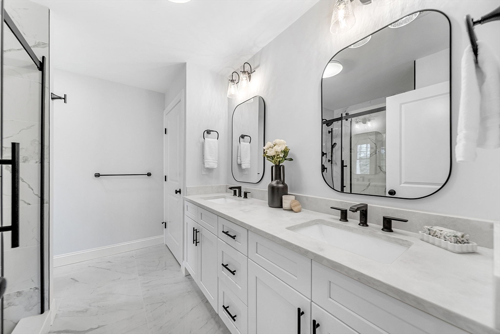 57 Raymond Street, Unit 2 Franklin, MA 02038 - Photo 22 of 41 a bathroom with double vanity sinks and a mirror