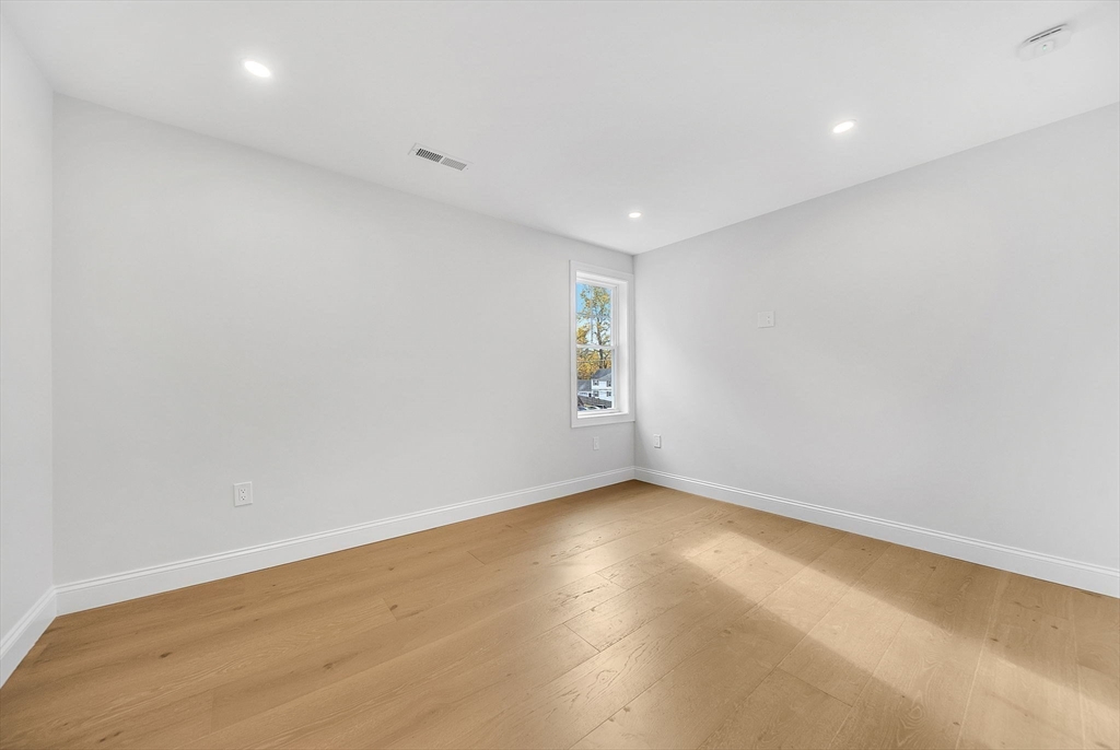 57 Raymond Street, Unit 2 Franklin, MA 02038 - Photo 27 of 41 an empty room with wooden floor and windows