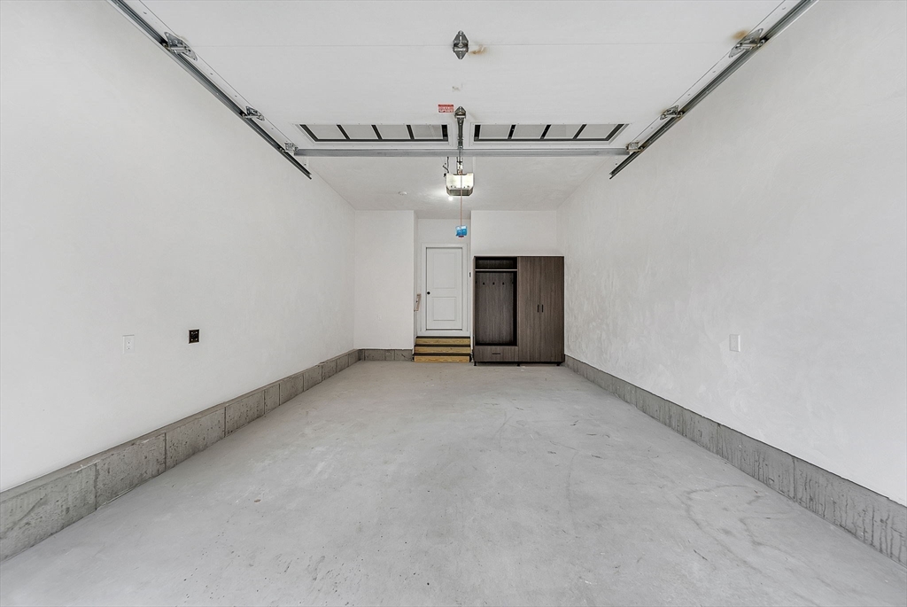 57 Raymond Street, Unit 2 Franklin, MA 02038 - Photo 36 of 41 an empty room with a ceiling fan and window