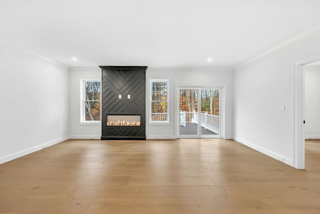 57 Raymond Street, Unit 2 Franklin, MA 02038 - Photo 9 of 41 a view of an empty room with a window and a kitchen