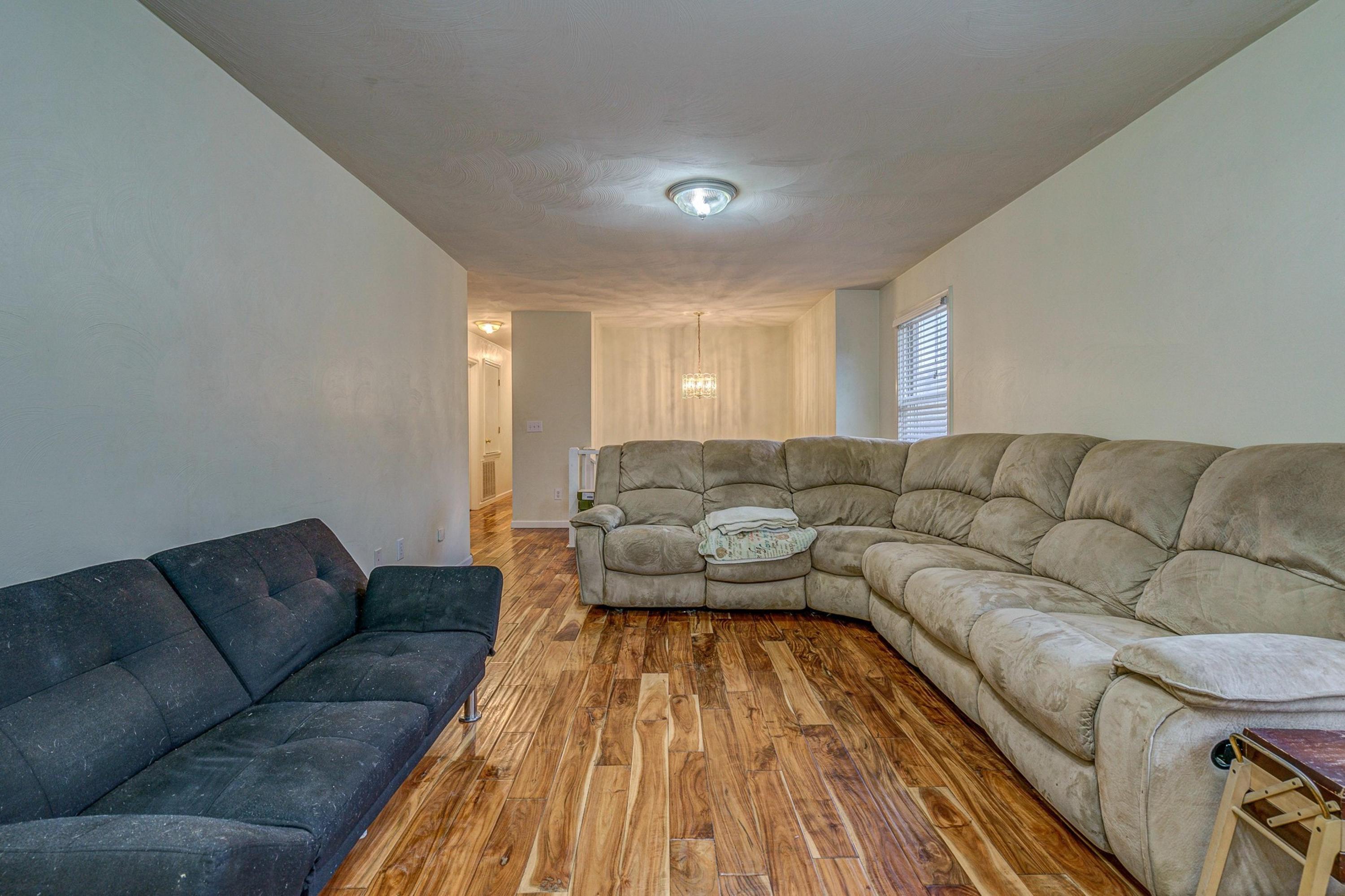6071 Goodview Road Goodview, VA 24095 - Photo 11 of 44 a living room with a couches and kitchen view with wooden floor
