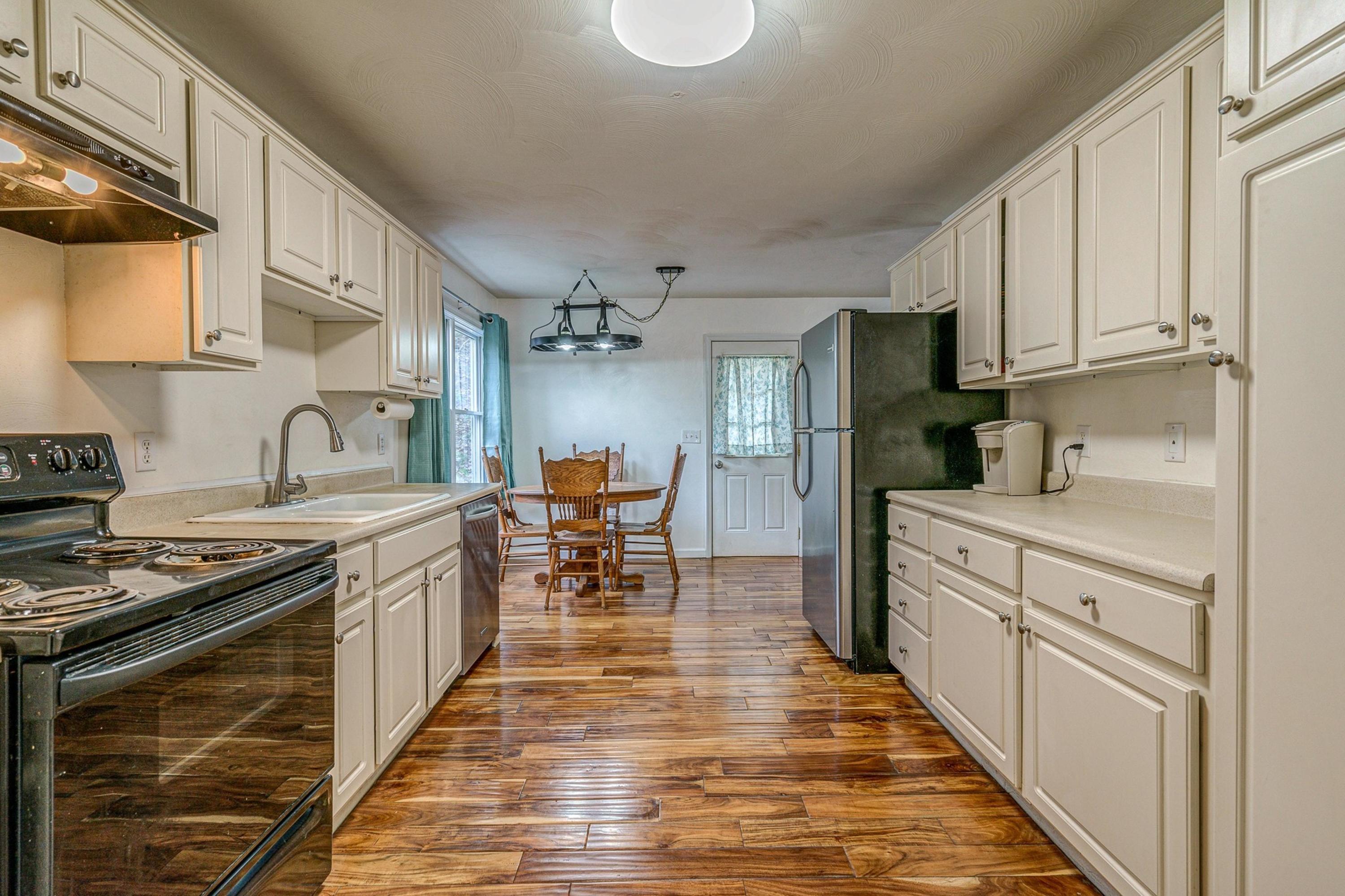 6071 Goodview Road Goodview, VA 24095 - Photo 12 of 44 a kitchen with stainless steel appliances granite countertop a stove and a sink