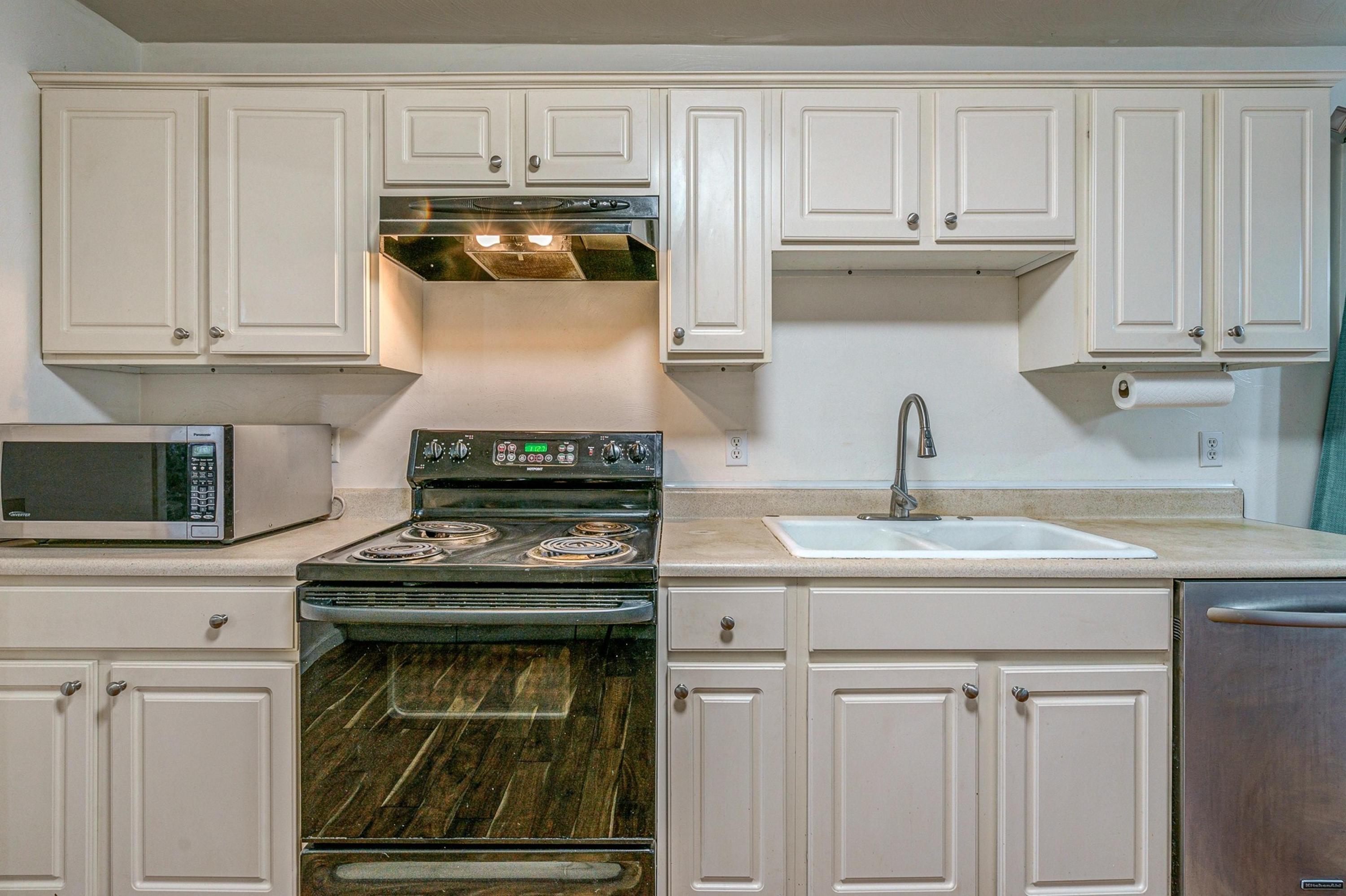 6071 Goodview Road Goodview, VA 24095 - Photo 13 of 44 a kitchen with white cabinets and appliances